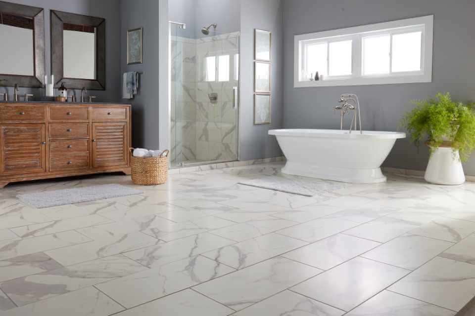 A bathroom with a white tile floor